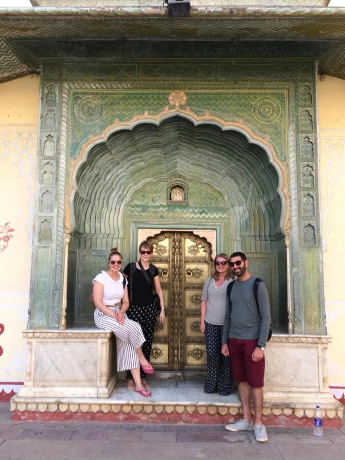 Guests at a painted Jaipur doorway