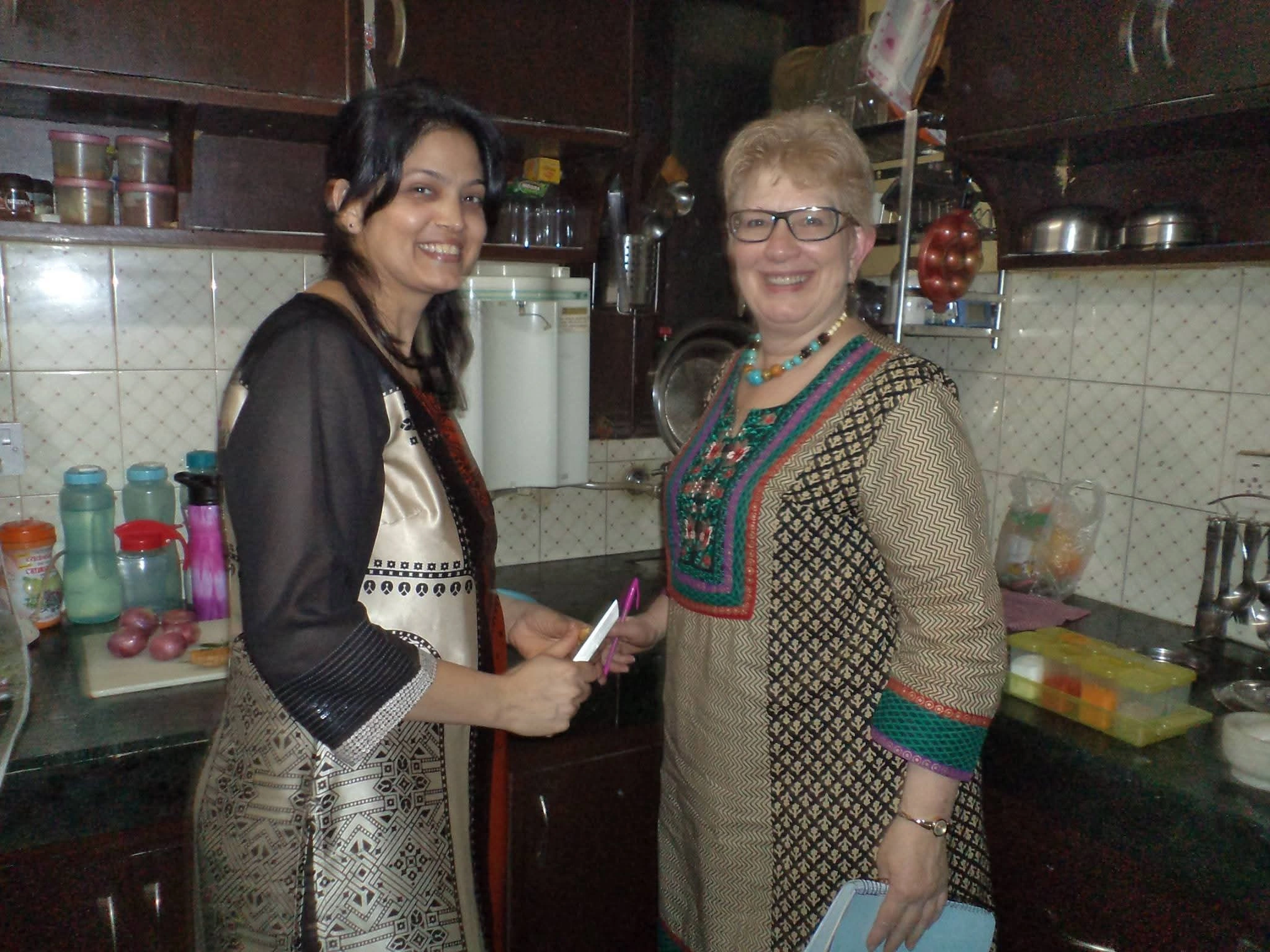 A guest and Neelima during a hosted kitchen encounter