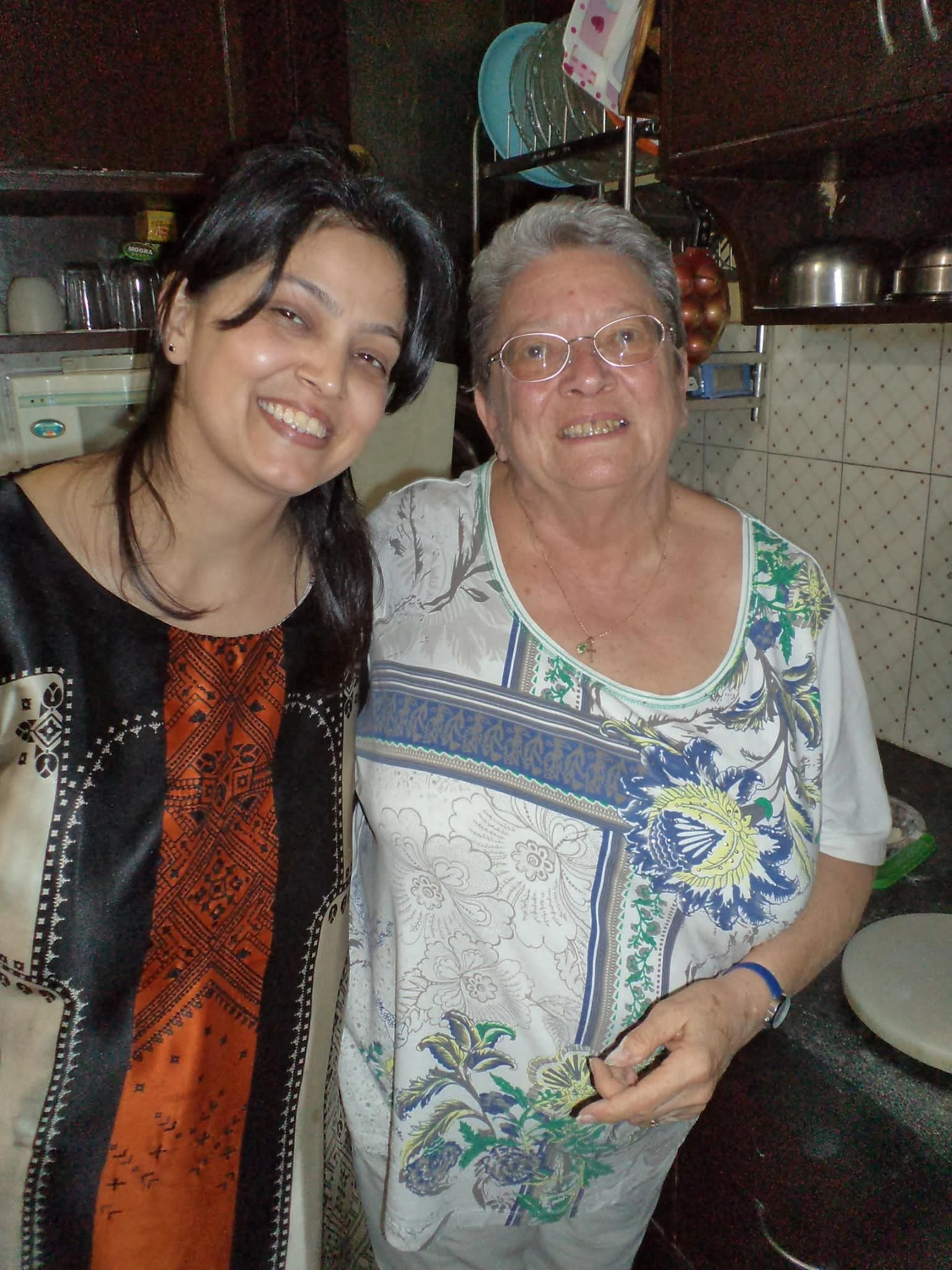 Neelima with a guest in a home kitchen during a hosted cultural moment