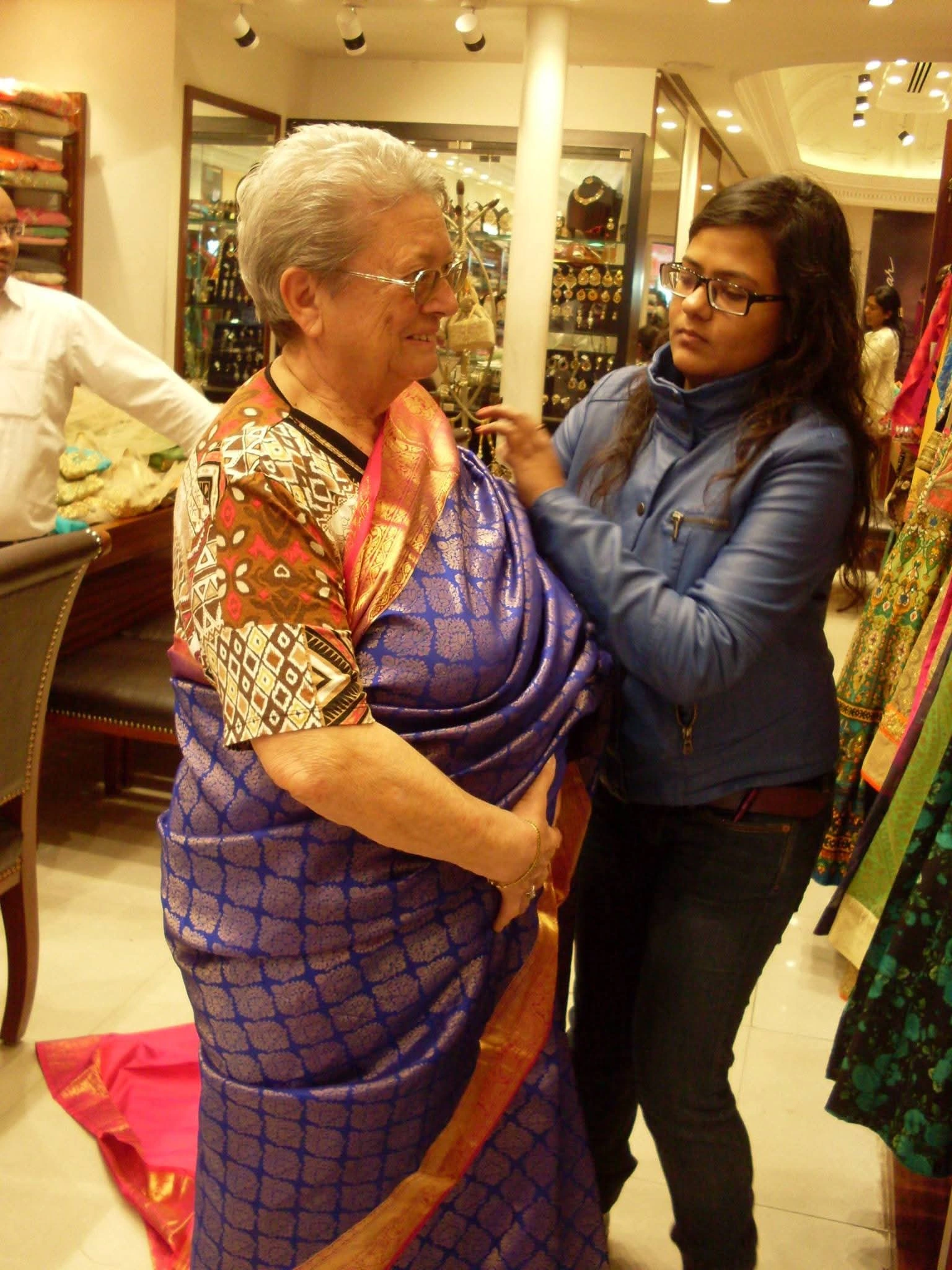 Neelima helping a guest understand Indian textiles