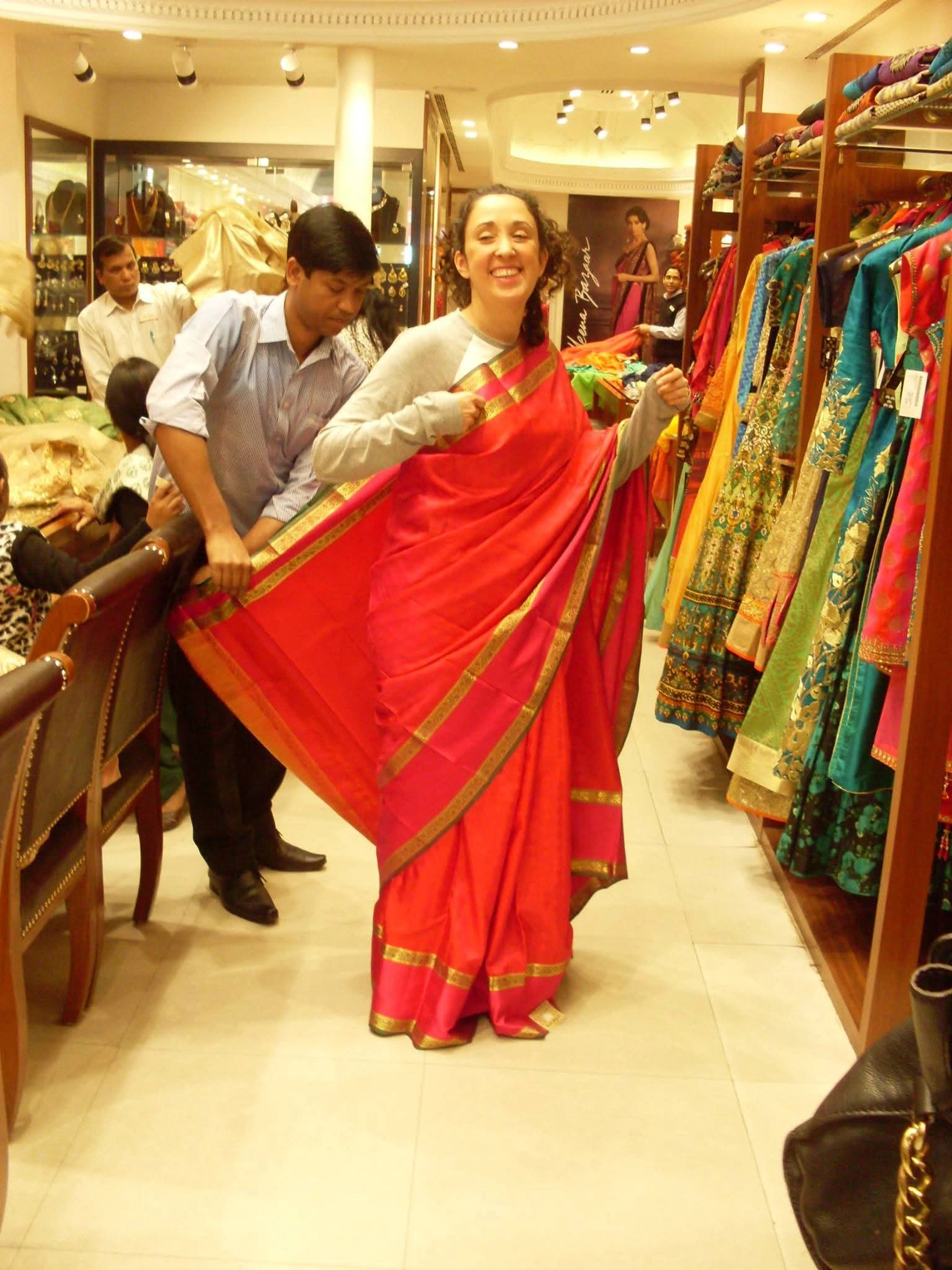 A guest trying a red sari