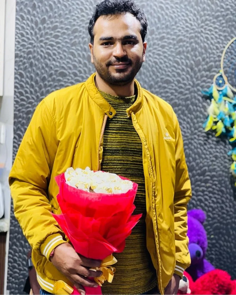 Sulabh Jain, founder of Epic Indian Travel, holding flowers